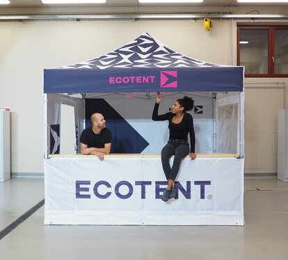 rinted Ecotent® folding gazebo with counter, two people talking.