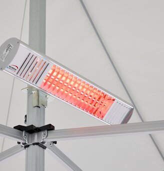 The heater is mounted on the central pole of the folding gazebo. The radiant heater is on.